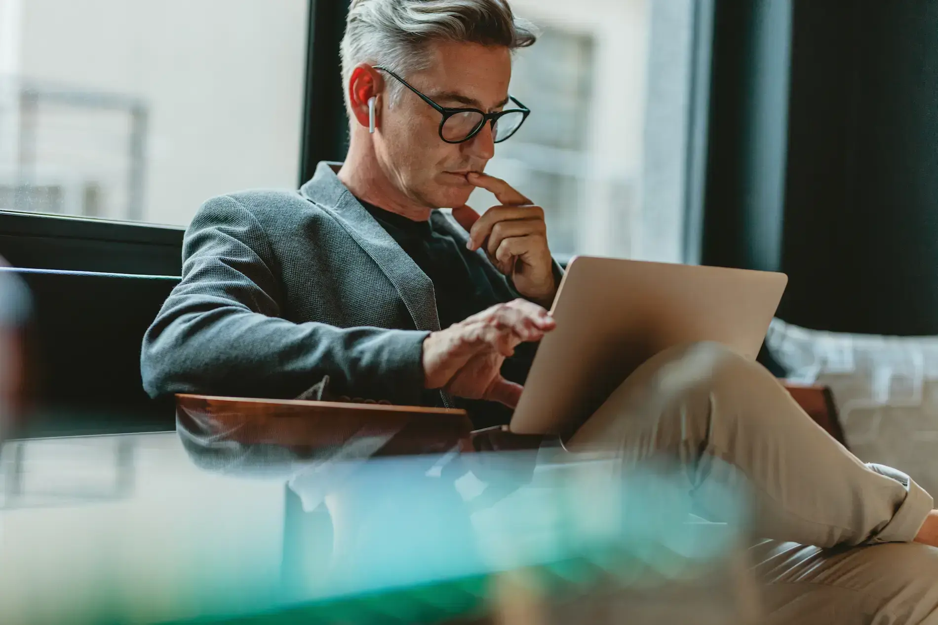 Business professional using a tablet in a modern office, representing secure digital access and information management.