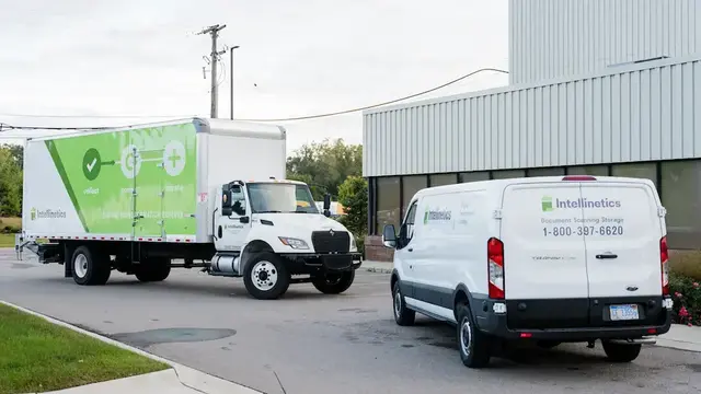 Intellinetics branded truck and van used to securely transport documents for scanning, storage, and records management services.