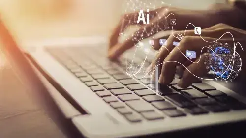 Hands typing on a laptop with AI and digital technology graphics representing intelligent automation and connected information.