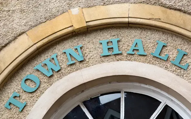 Close-up of the words town hall on the front of a municipal building