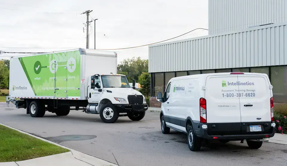 Intellinetics branded truck and van used to securely transport documents for scanning, storage, and records management services.