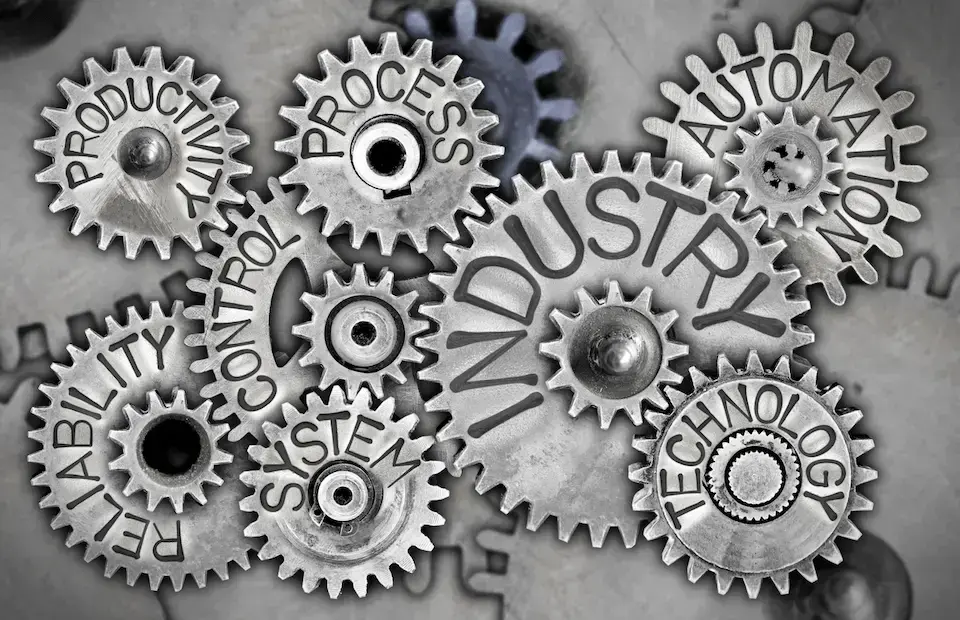 Macro photo of tooth wheels with INDUSTRY concept related words imprinted on metal surface