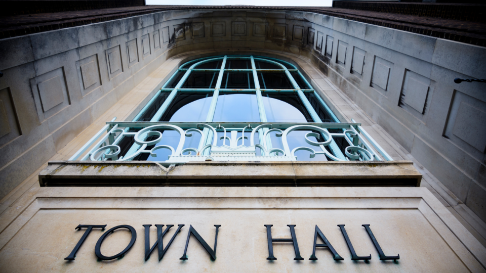the front of a municipal building with a close-up on the words Town Hall