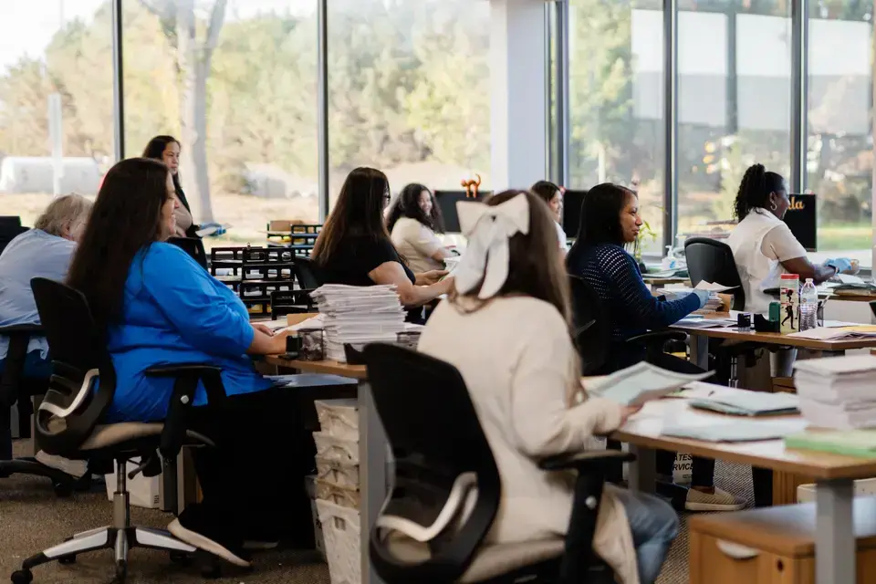 Intellinetics BPO team processing documents and managing information in a professional office environment.